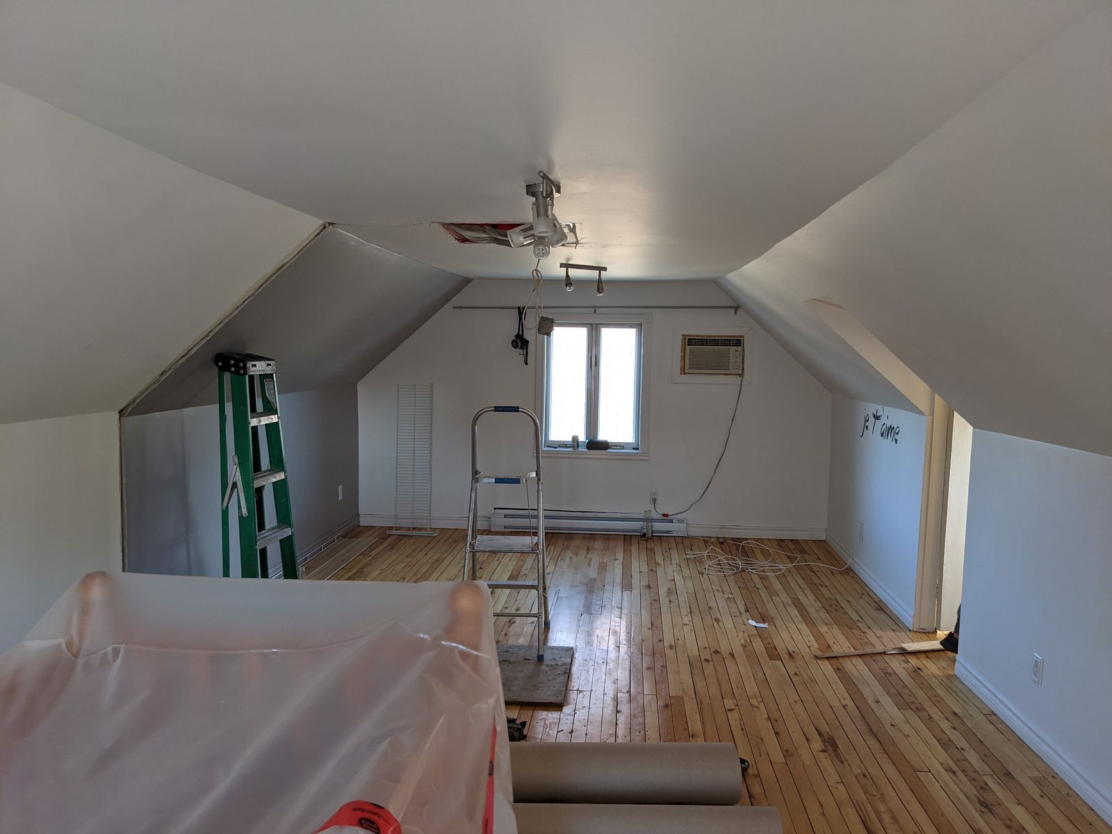 Étage ajouté vu de l’intérieur, plafond mansardé refermé et plancher de bois protégé
